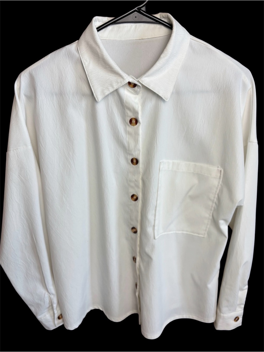 Women's long sleeve oversized white polyester button down blouse.